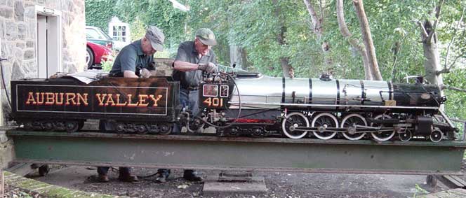 Two gentlemen in engineer caps working on the 4-8-4 Northern Engines #401, the side of the train reads in all caps "Auburn Valley"