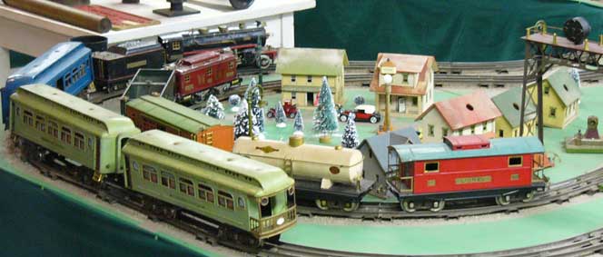 Several toy trains on a circular portion of a track