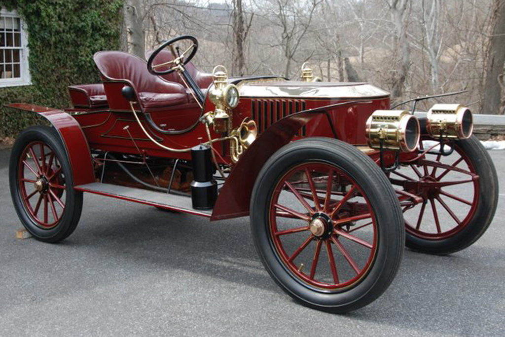 The 1907 Stanley Semi-Racer Model K is an all red car, that has gold embellishments on it. There is no top to the car