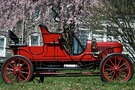 The 1908 Stanley Model EX has an open top, red wheels and a red body