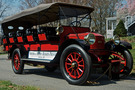 The 1915 Stanley Mountain Wagon Model 820 has a red body and red wheel spokes. This car, sometimes called a "steam bus" has five rows of seats. There is a sign on the side that says "Friends of Auburn Heights, Yorklyn, DE"