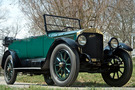 The 1918 Stanley Model 735 has a forest green body with black wheel spokes. The top of the car is down 