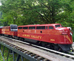 The F-7 Double Unit is a diesel train that is red and has the words "Auburn Valley" painted on the side in yellow letters
