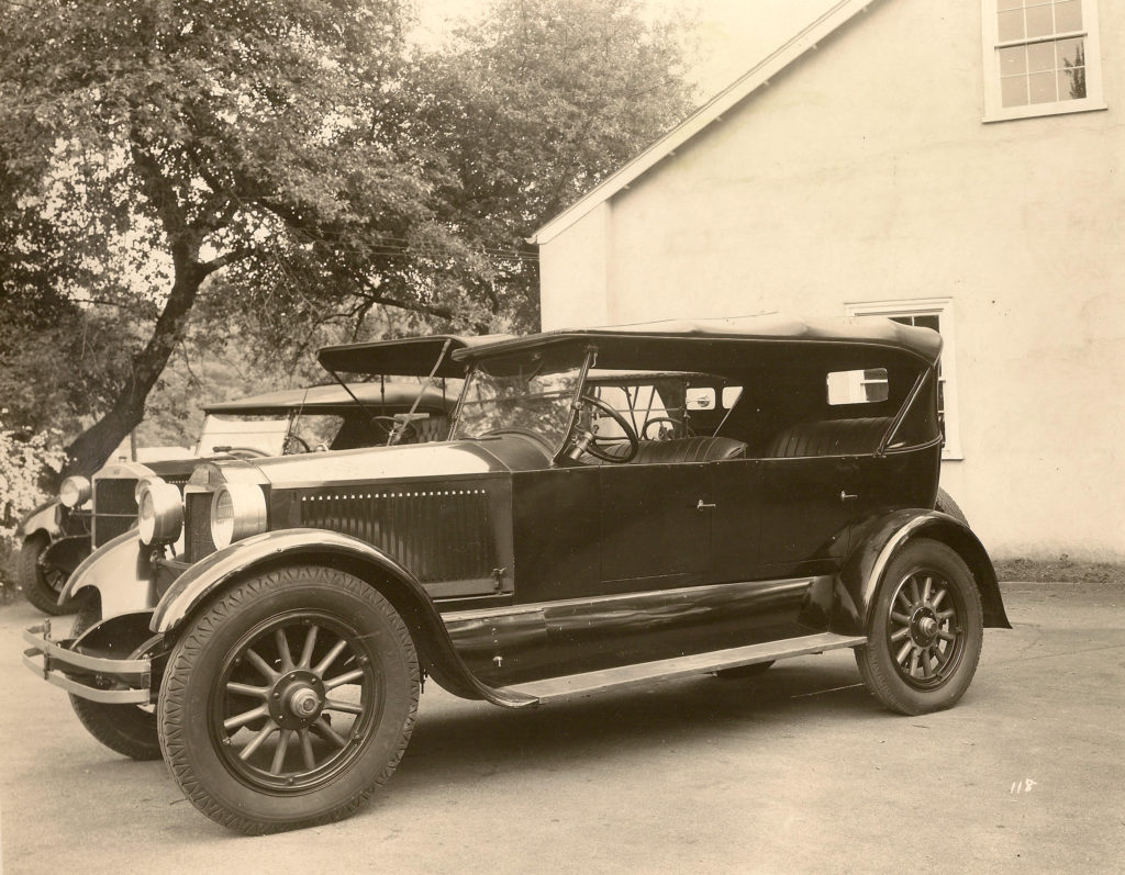 The 1924 Stanley Model 750 is an all black car, and the side of it is shown in this black and white photo