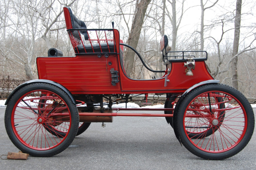 The 1902 Stanley Stick-Seat Runabout is an all red car, with black seats and black tires. It is carriage shaped, and the drivers seat is behind the passengers