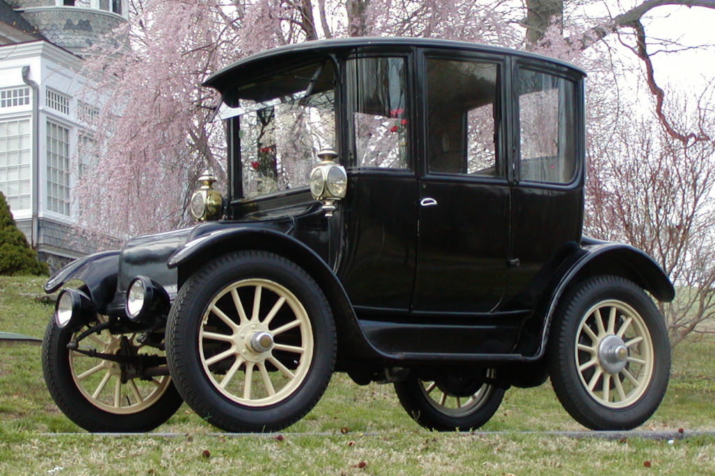 The 1916 Rauch and Lang Electric car is an all black vehicle with yellow wheel spokes