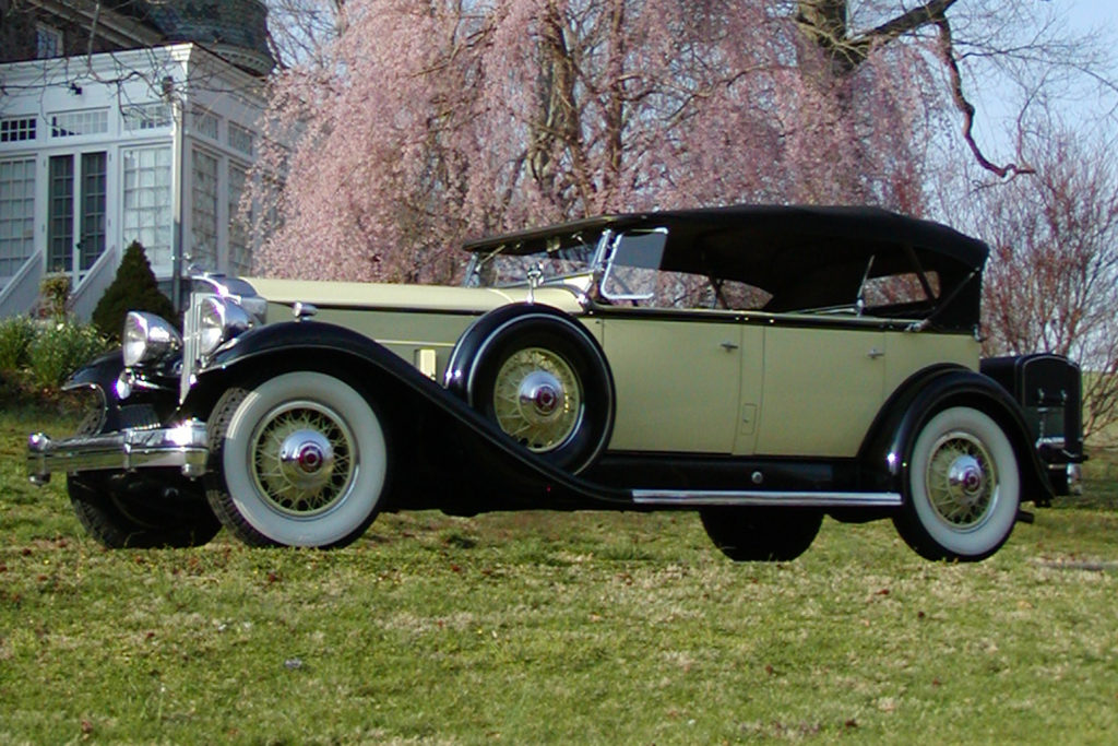 The 1932 Packard Model 905 is a yellow car with black detailing