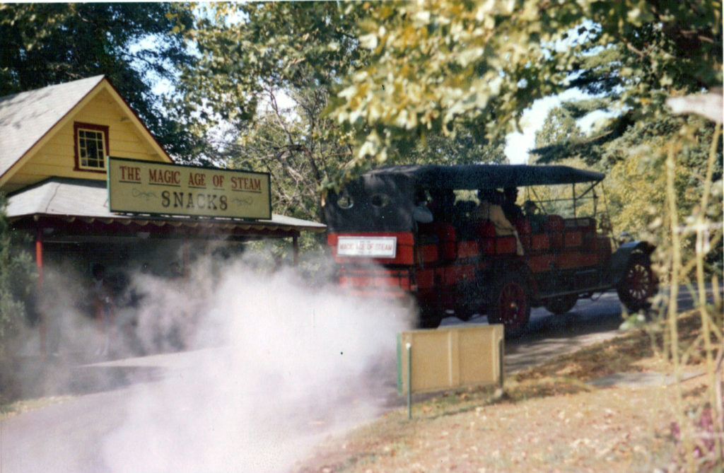 The back of the Mountain Wagon is shown passing in front of a sign that reads "The Magic Age of Steam, Snacks"