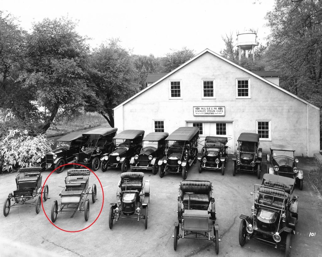 In this black and white photo several antique cars are parked in front of the Marshall Steam Museum